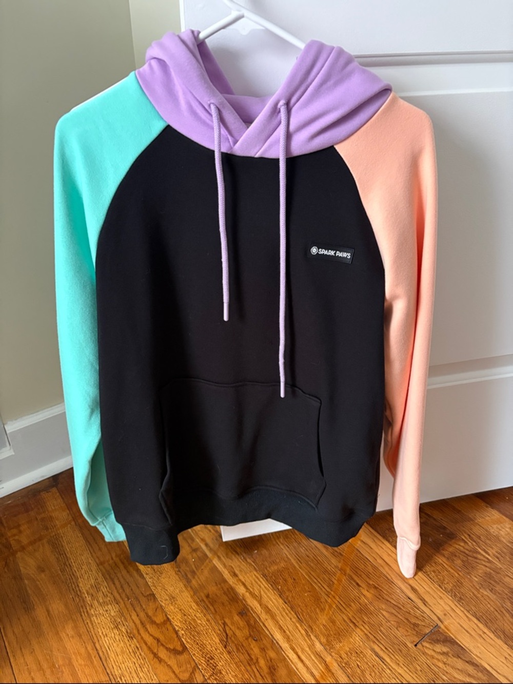 Colorblock Unisex Hoodie - Black with Mint, Lavender & Peach Accents.